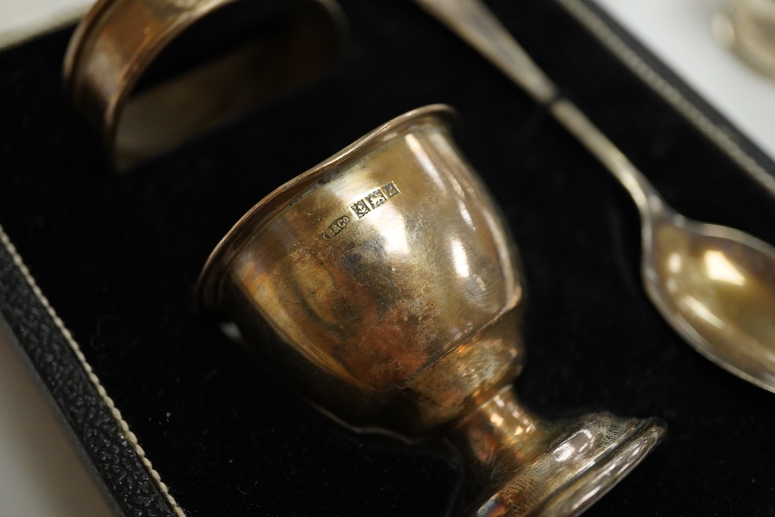 An Elizabeth II cased silver christening trio, Birmingham, 1959/60, together with three silver napkin rings.